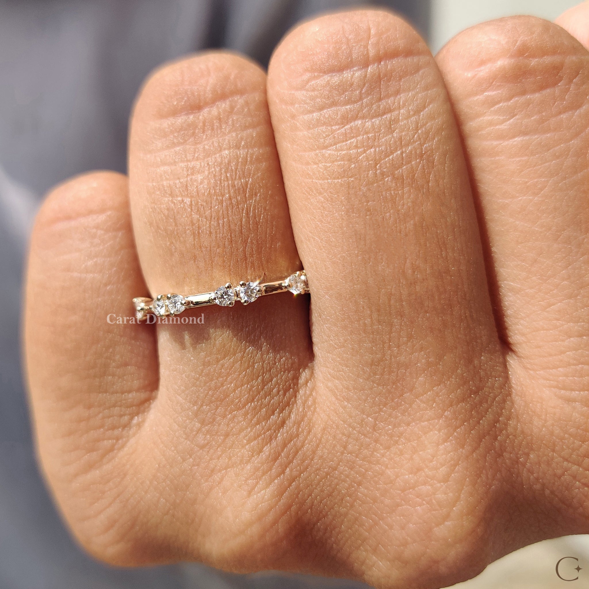 Simple prong set diamond duo band in yellow gold.
