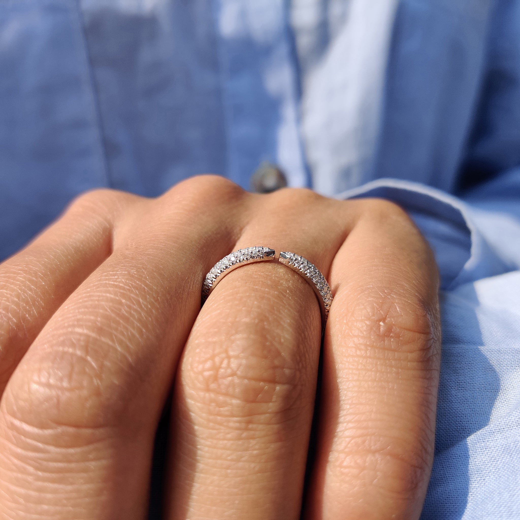 Round cut moissanite set in a sleek, simple band, perfect for modern brides.