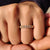 Trellis eternity band with cushion cut light yellow moissanite in a shared prong setting.