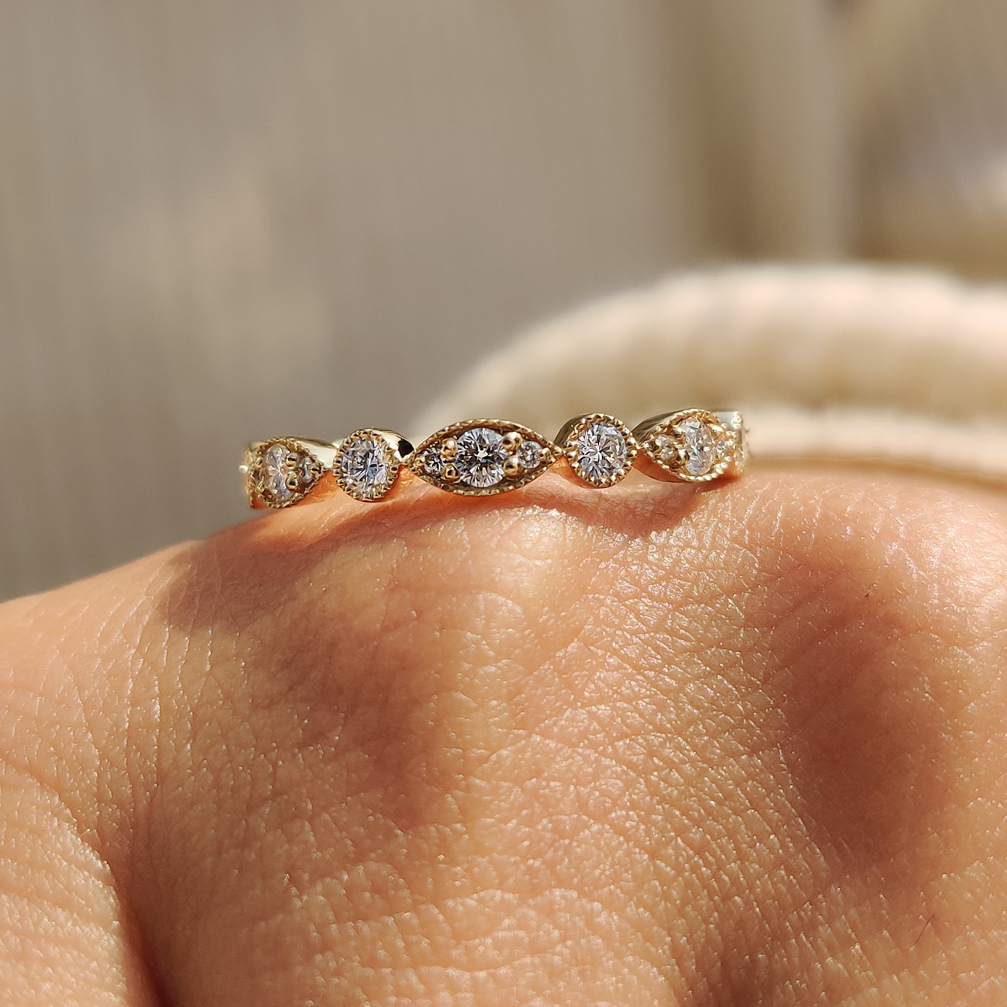 Carat diamonds wedding band highlighted on a marble surface.
