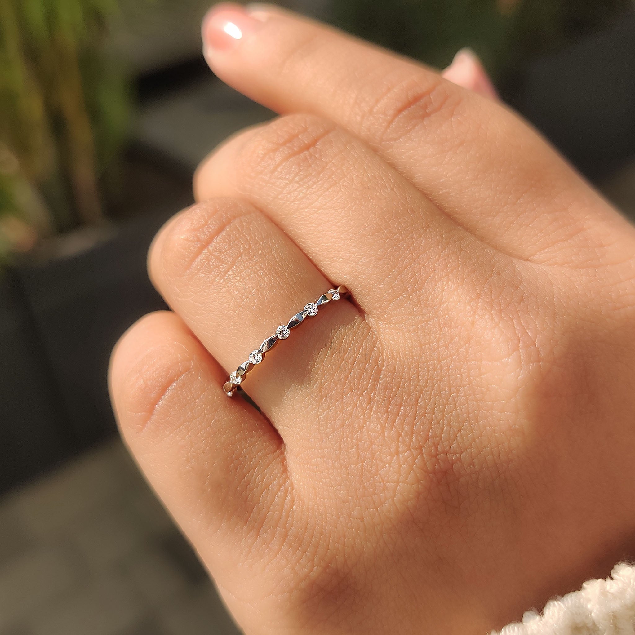 Custom white gold wedding band with round cut diamonds and minimalist design.
