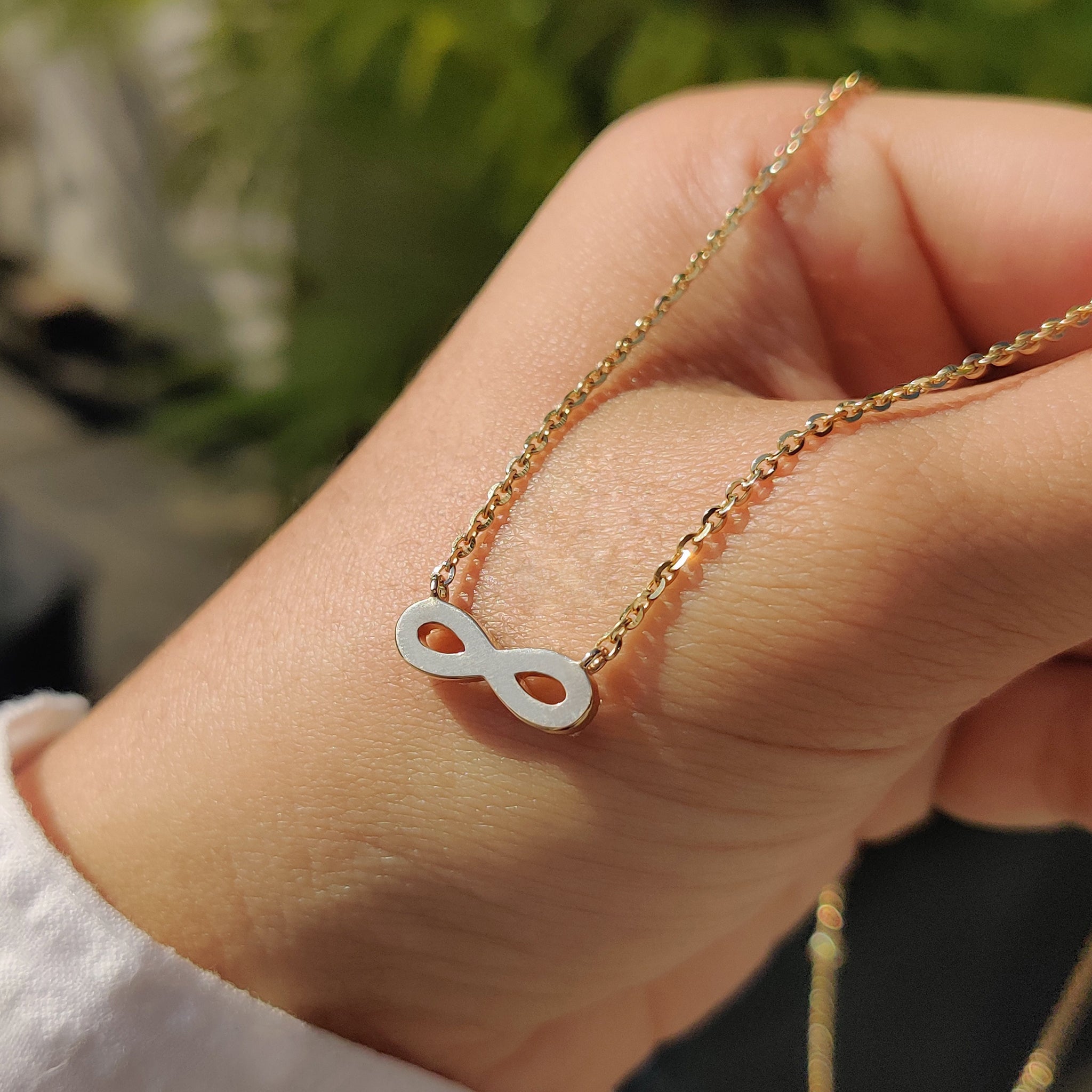 Carat Diamonds round diamond infinity pendant.