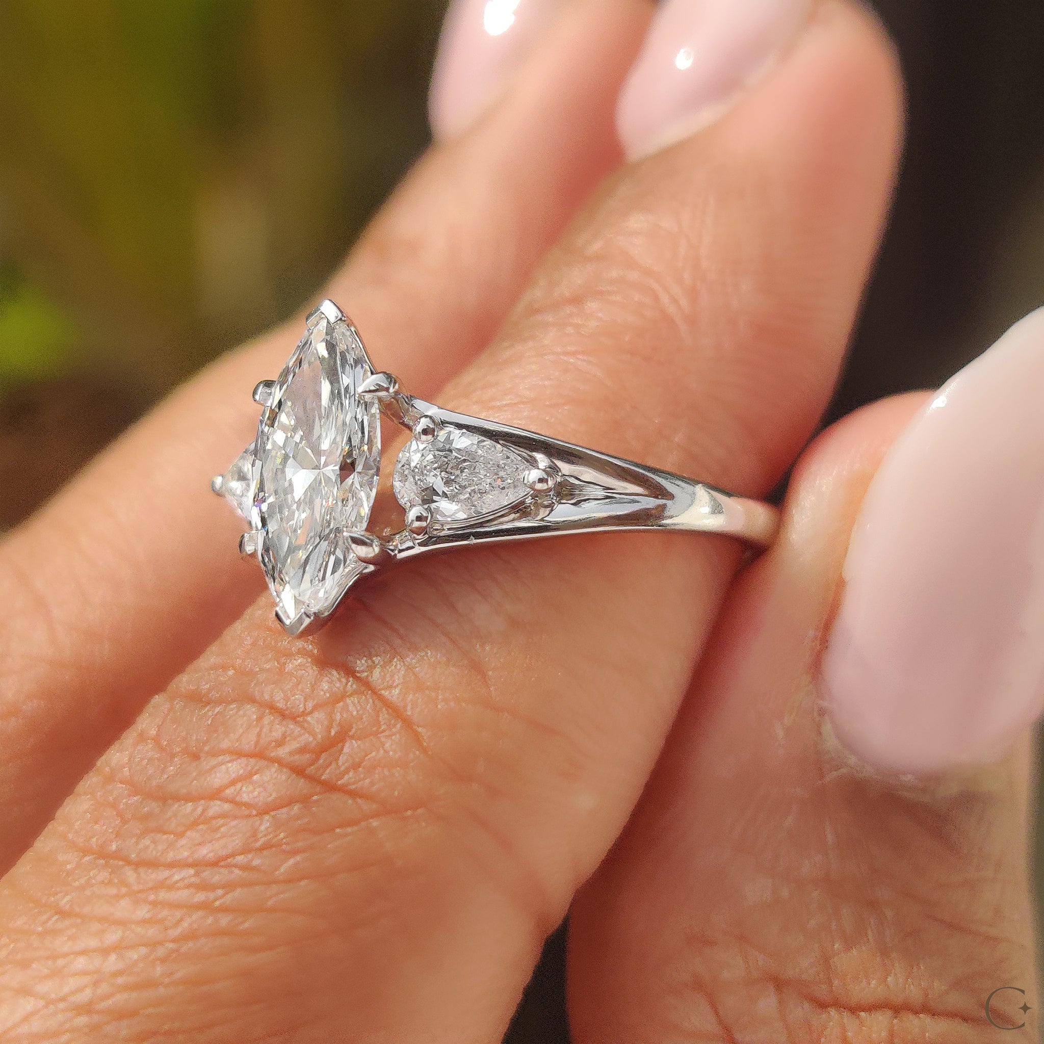 Custom engagement ring featuring marquise and pear cuts.
