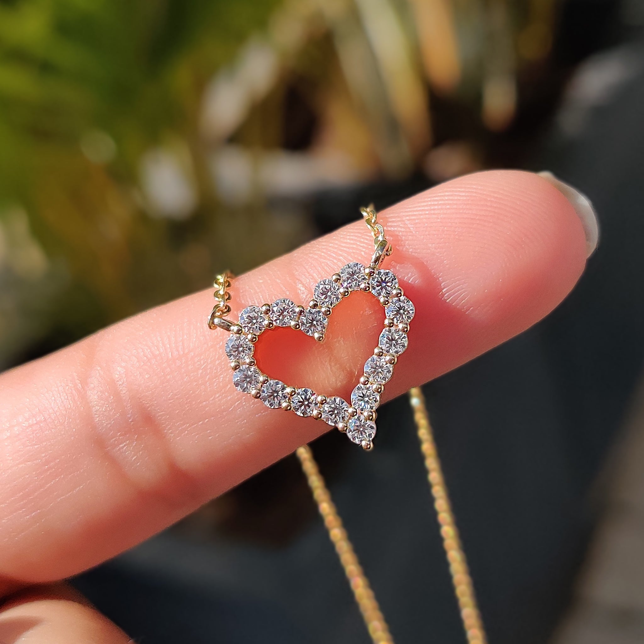 Round pendant in yellow gold with diamond accents.
