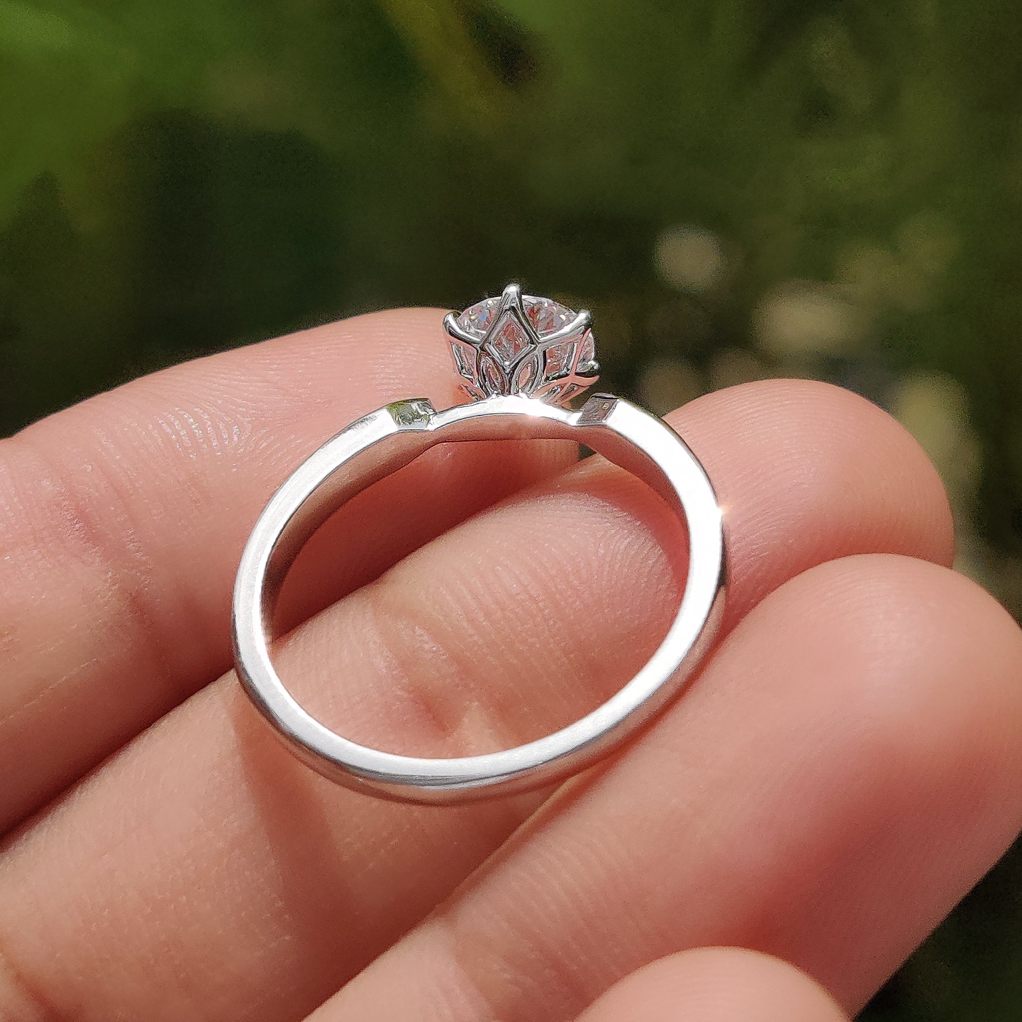 Round solitaire engagement ring with tulip setting ring.

