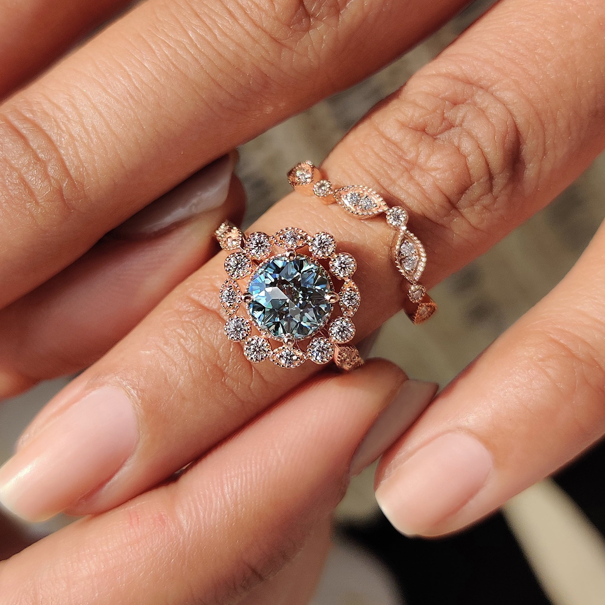Handmade bridal set featuring a halo setting ring and milgrain band.
