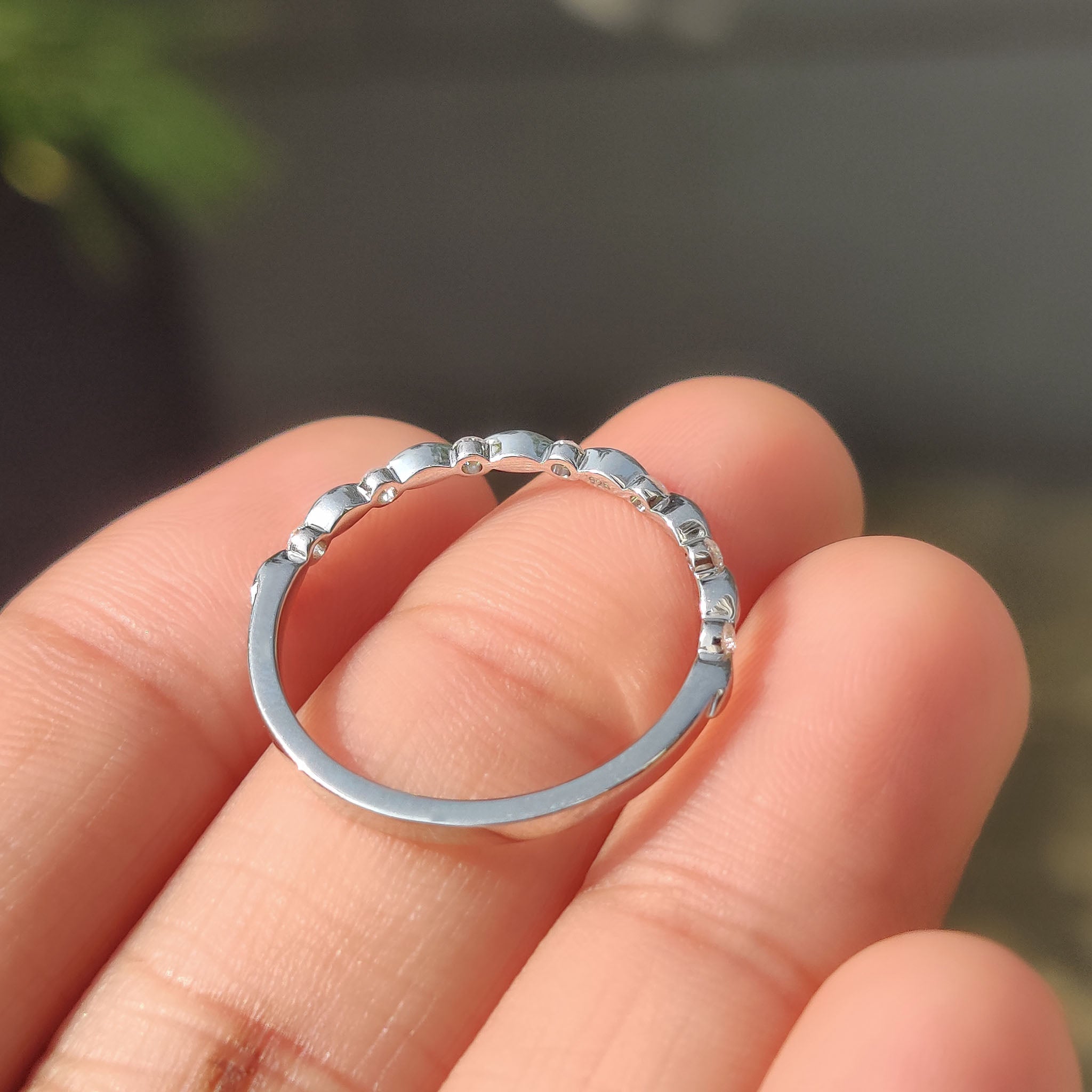 White gold stackable wedding ring with distance pave and minimalist design.
