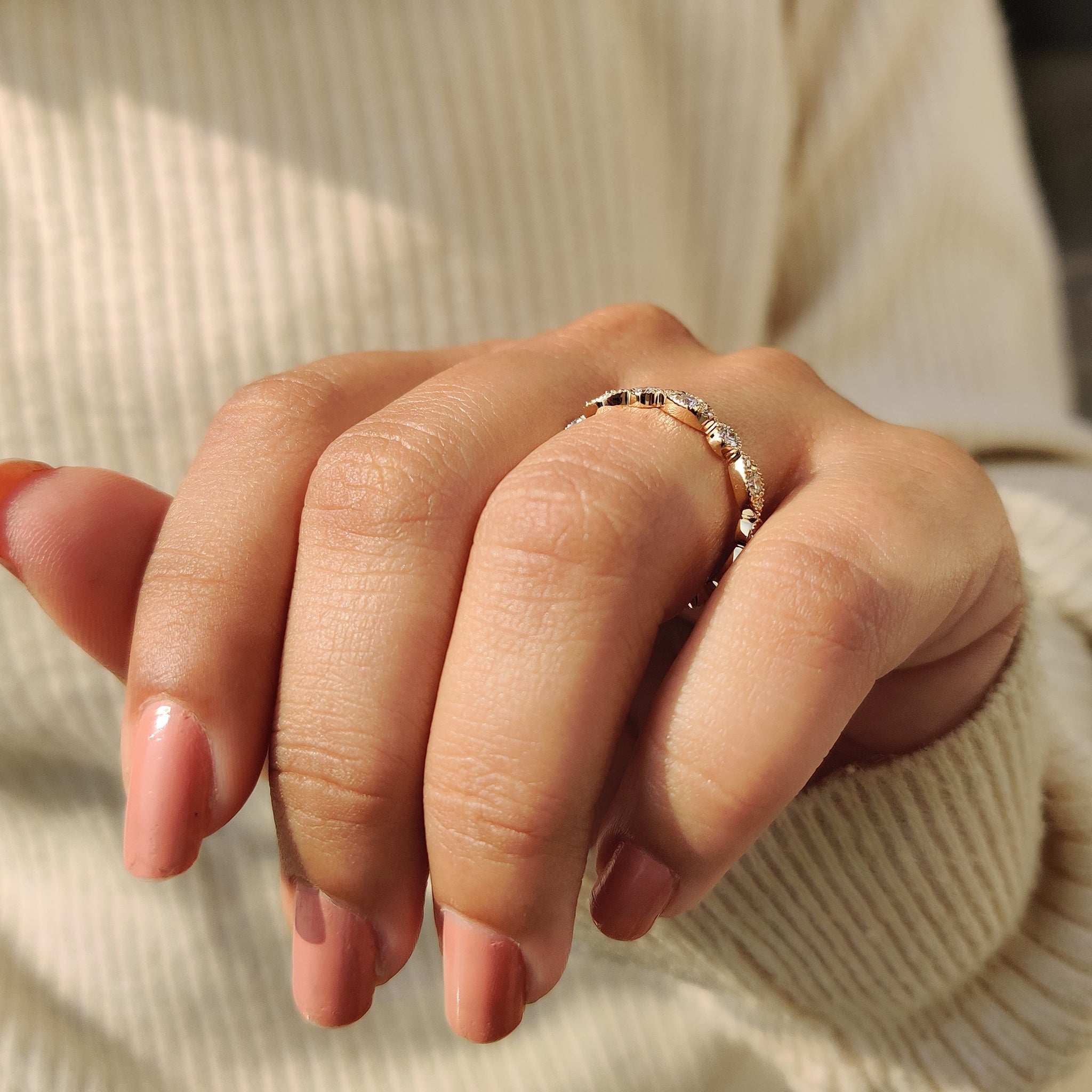 Stacked full eternity bands styled with other rings.
