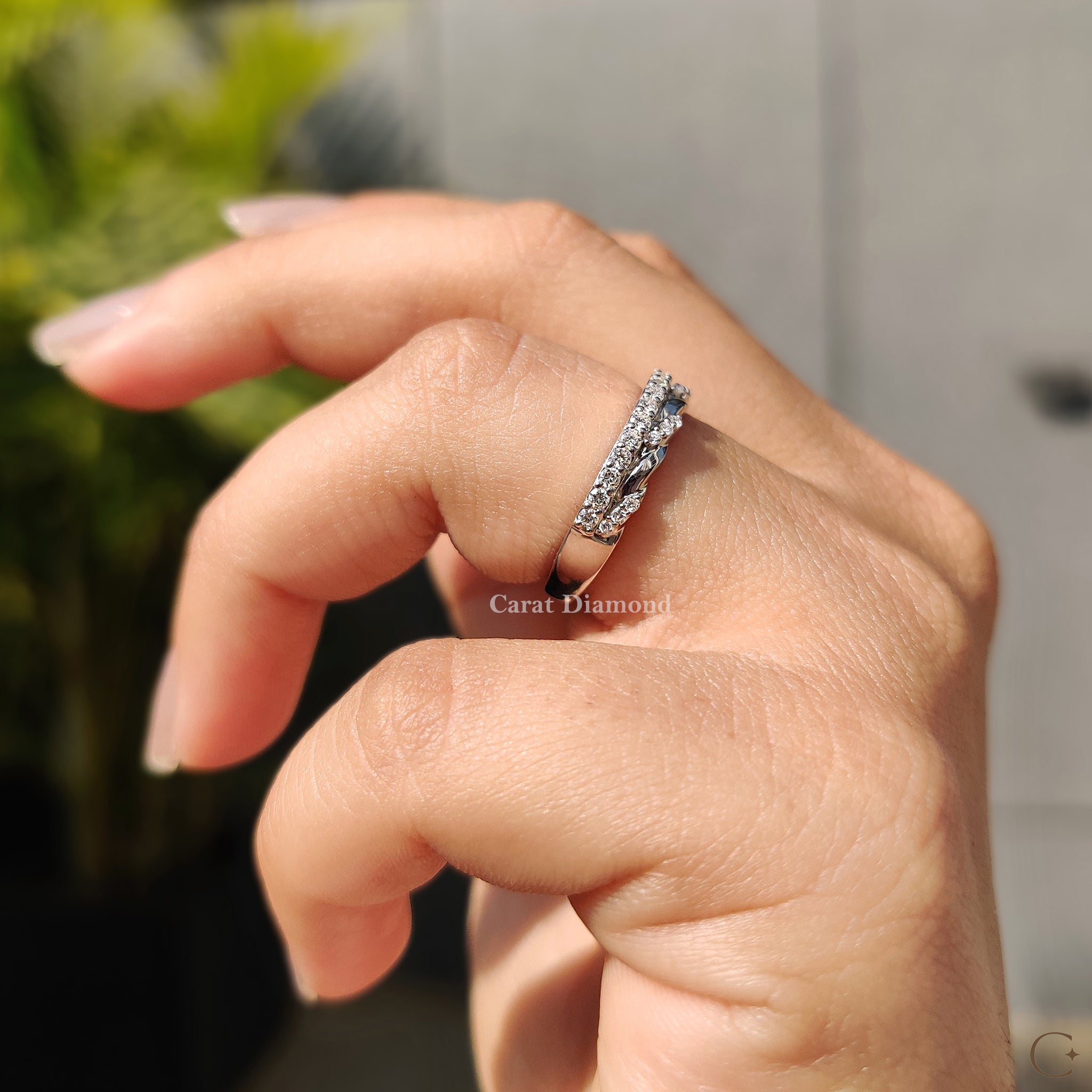 Carat diamonds band with round cut diamond details.