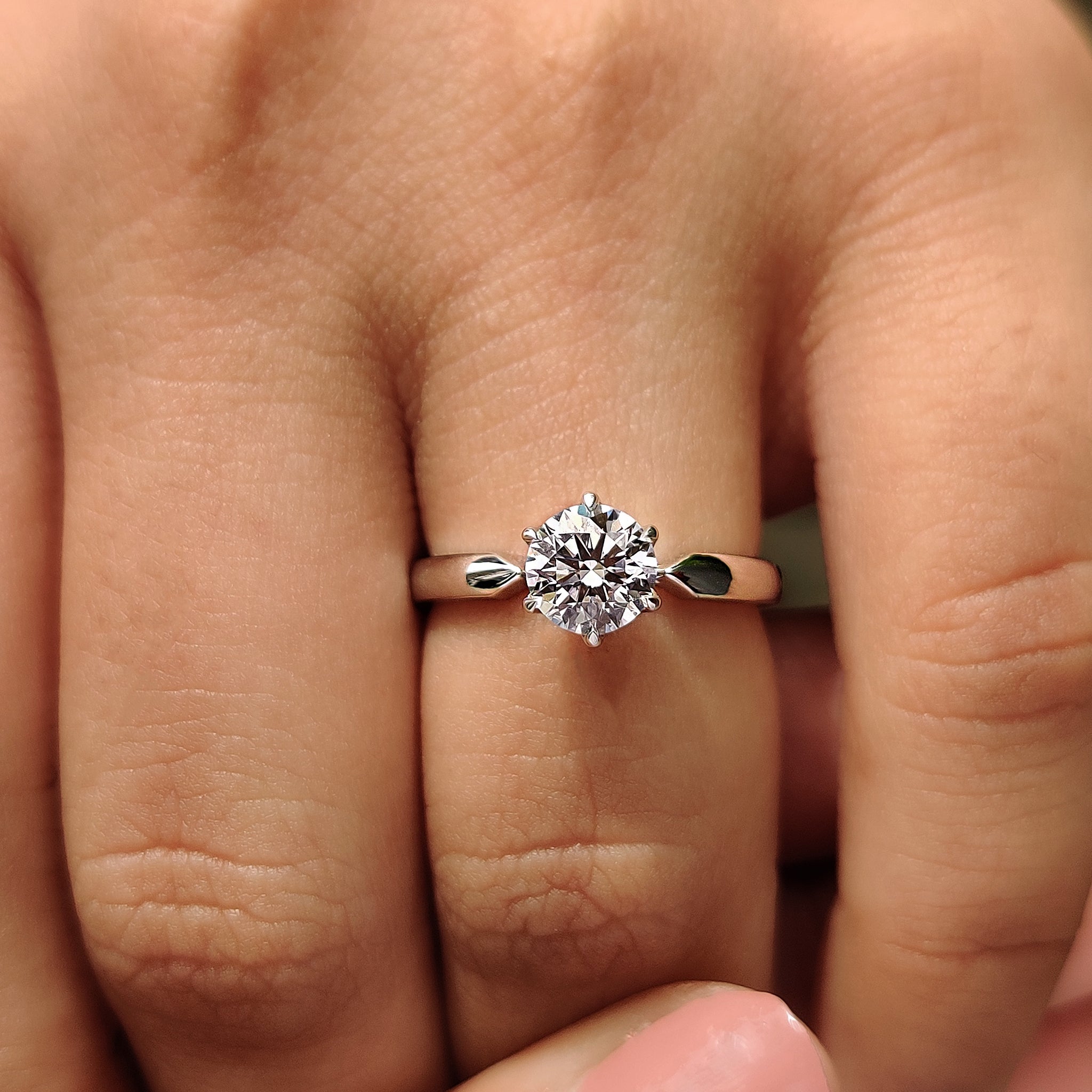 Round diamond engagement ring with 6 claw prong setting.
