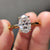 oval moissanite engagement ring with 4 prong setting and hidden halo design