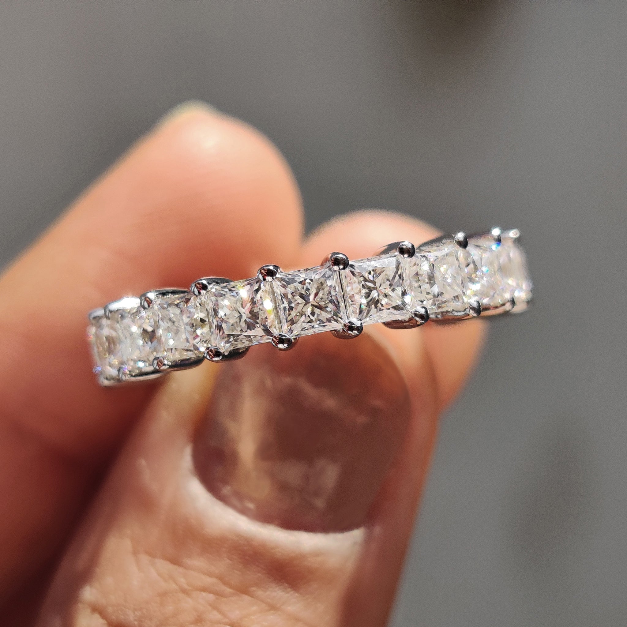 Princess cut moissanite wedding band crafted in a full eternity layout with clean edges.
