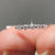 Shared prong wedding band with a sleek design.