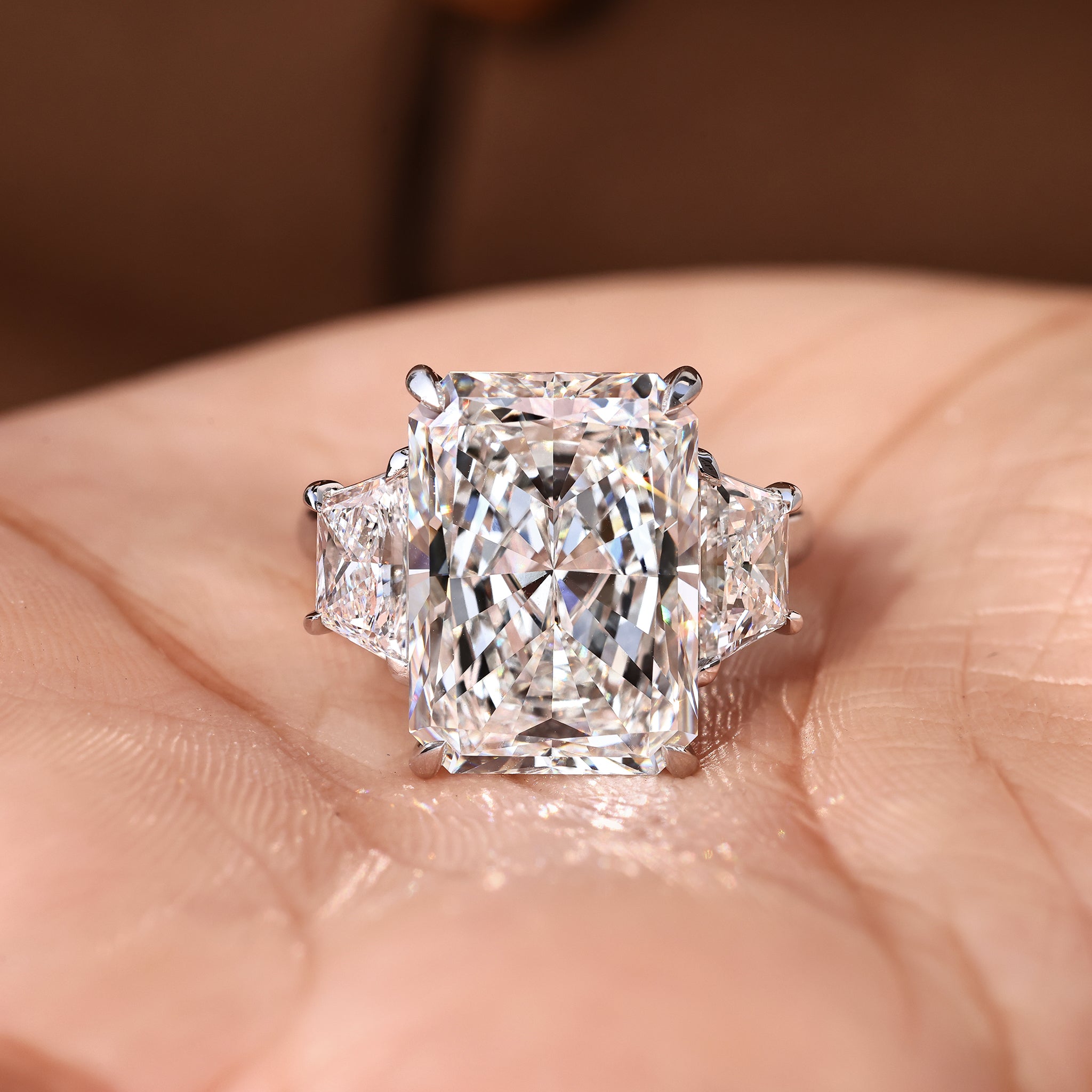 Handmade radiant cut diamond ring with refined three stone look.
