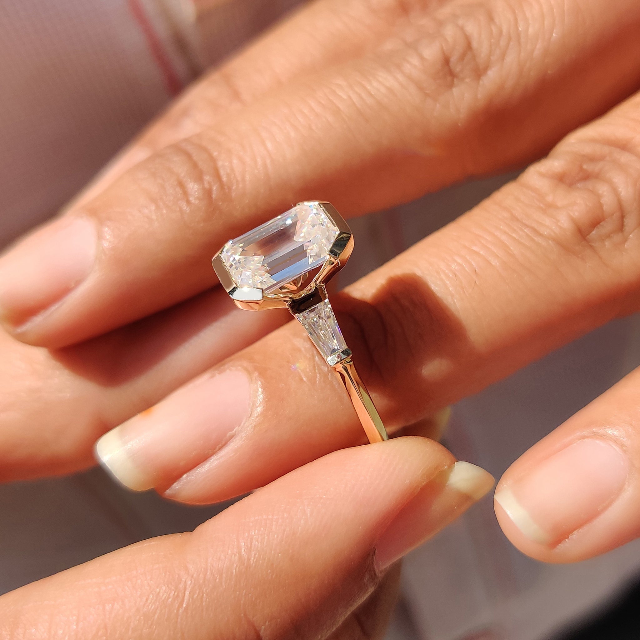 Custom yellow gold engagement ring with three stone setting