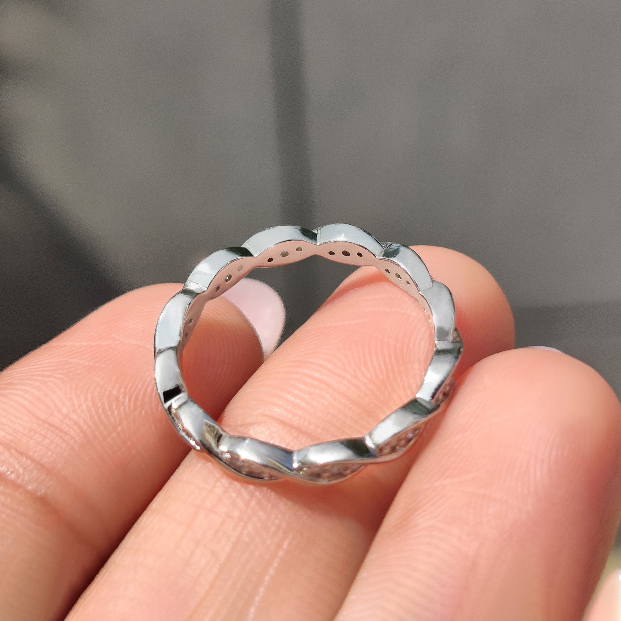 Handmade jewelry featuring a twisted eternity band.
