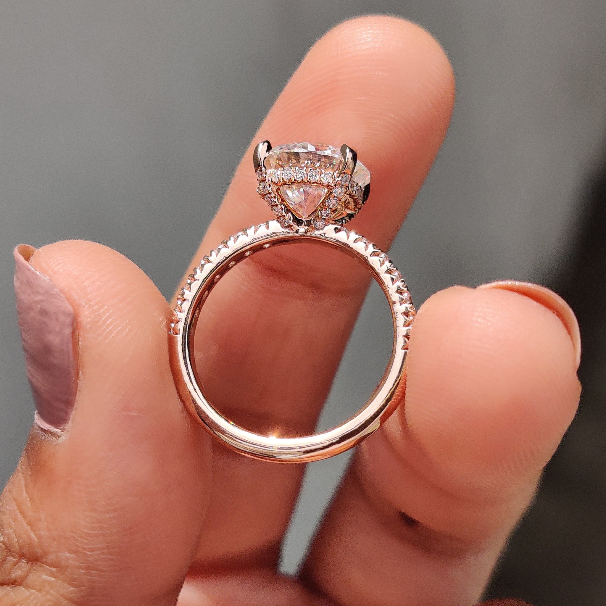 Rose gold engagement ring beams with rich deep warmth.