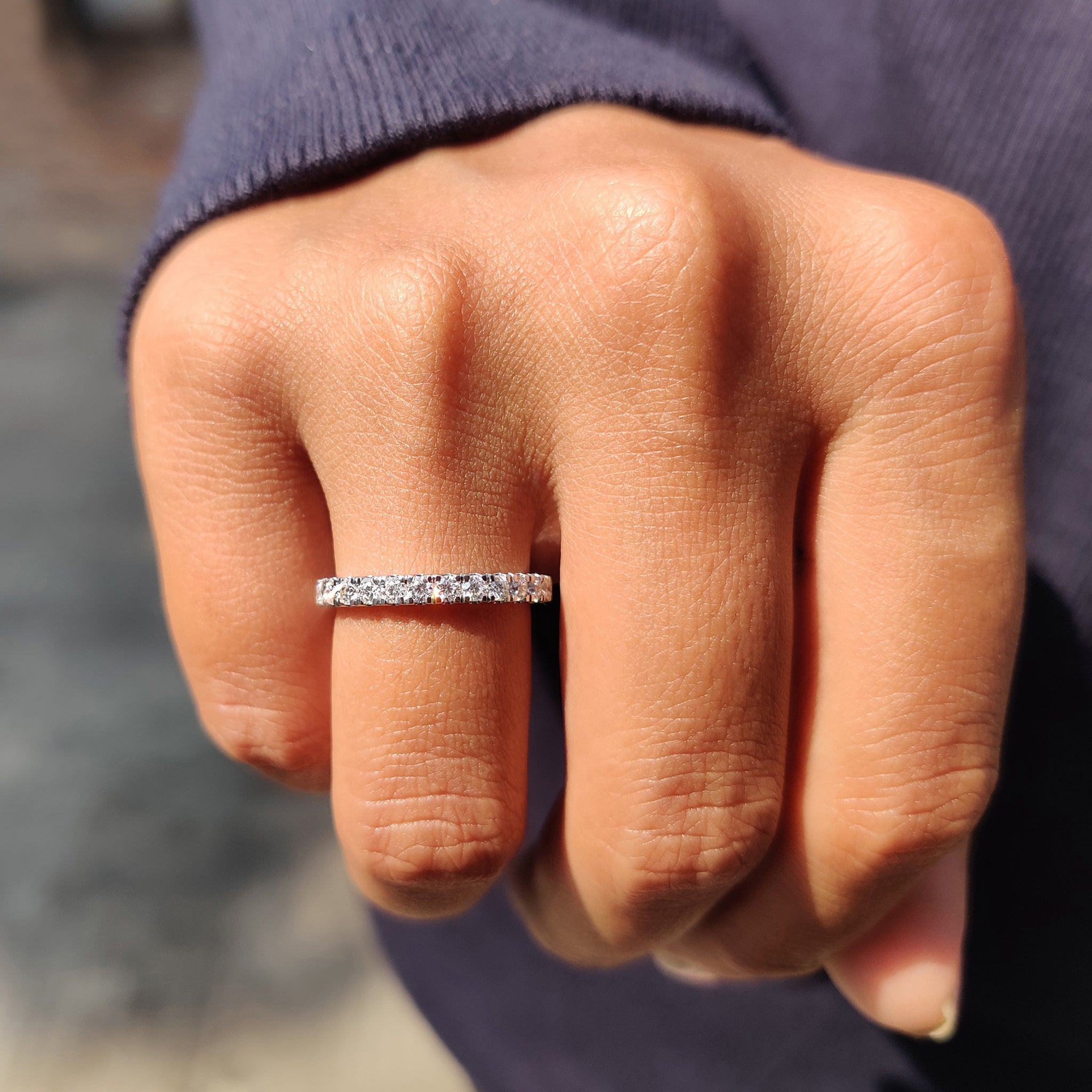 Handmade jewelry collection includes a round Moissanite wedding band with white gold setting.
