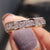 Channel set wedding band featuring delicate moissanite set in a modern style.