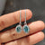 Cyan Blue Moissanite Dangle Drop Earrings crafted in white gold earrings with prong settings earrings.
