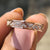 Moissanite eternity band featuring round moissanite stones set all around for continuous shine.