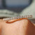 Yellow gold eternity band with round cut moissanite band.