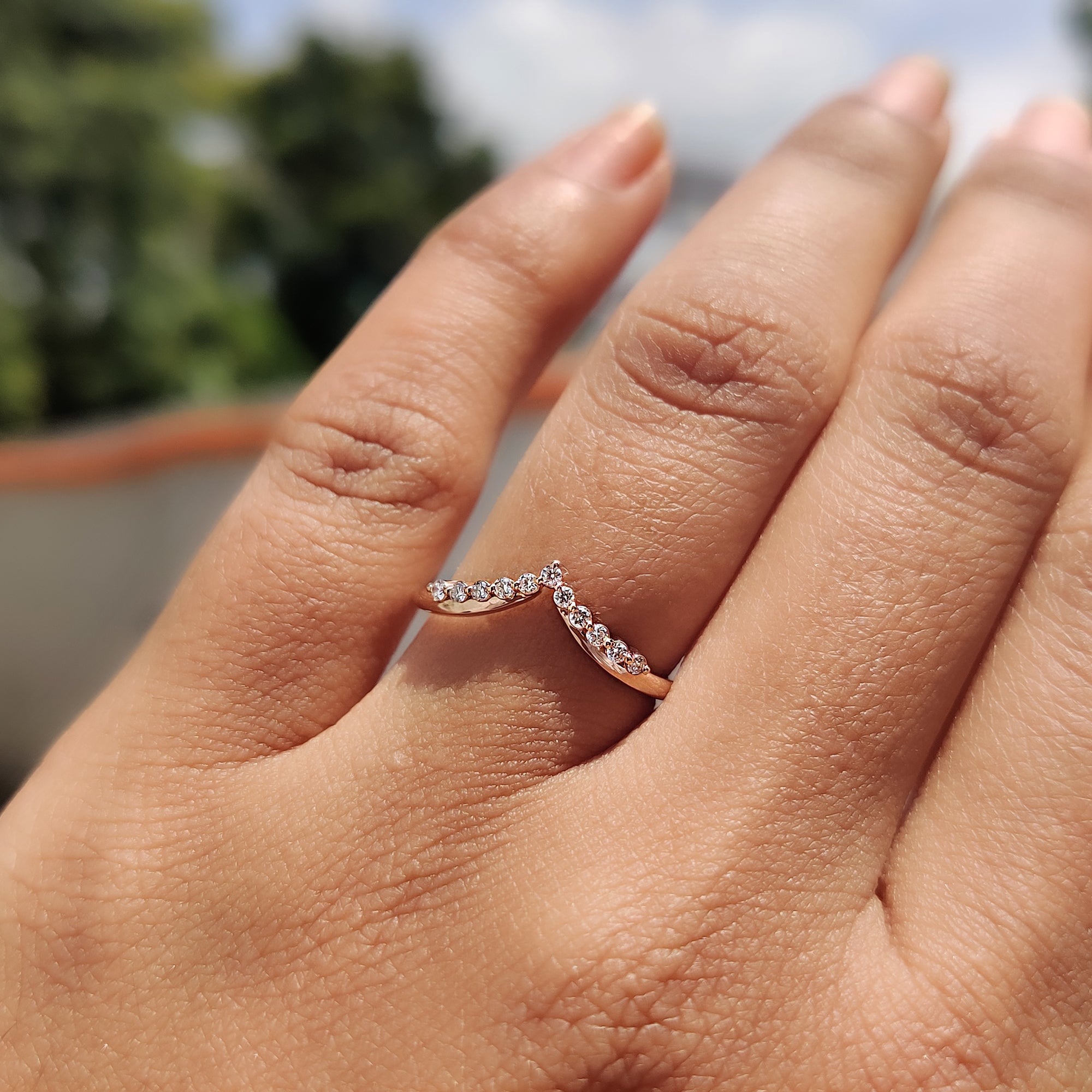 Chevron wedding band crafted in white gold with moissanite accents.