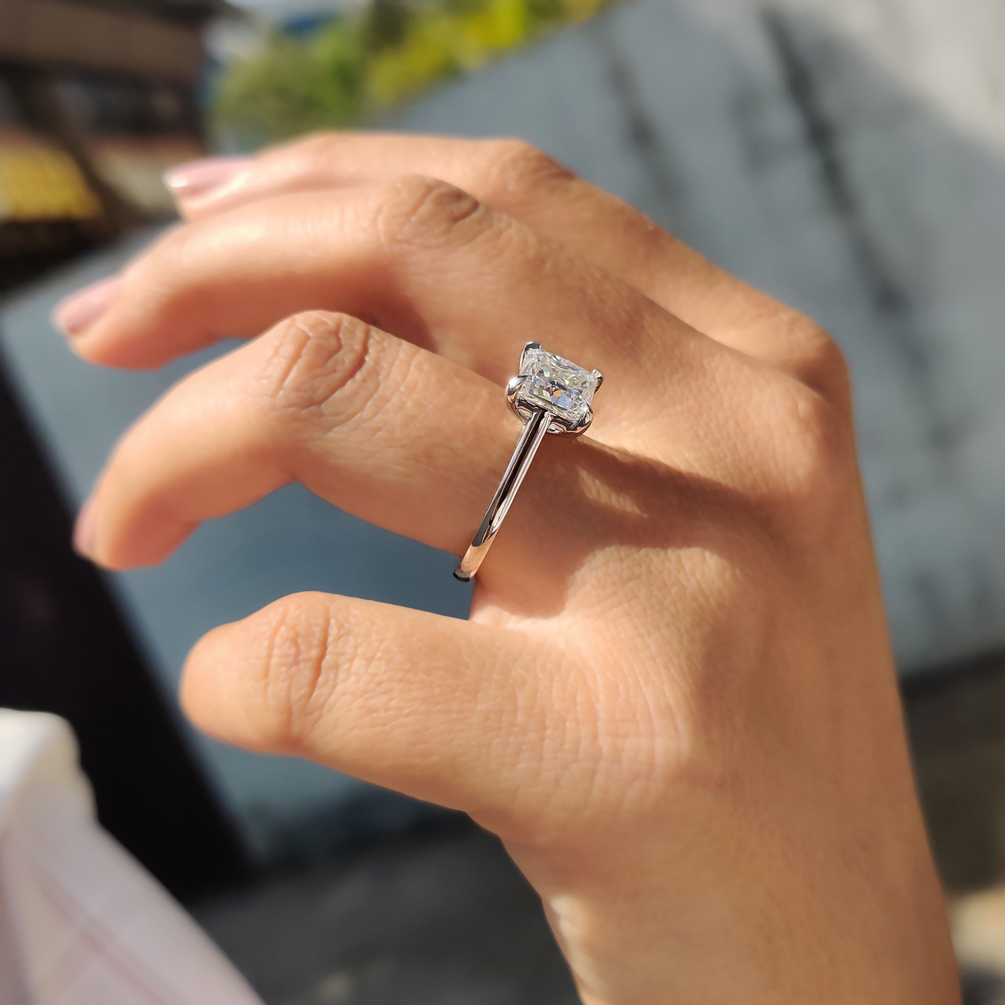 Women's anniversary ring featuring a princess cut Moissanite stone in a classic four claw setting.
