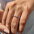 Full eternity band with prong set blue moissanite in a modern geometric layout.

