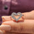 White gold engagement ring with heart shape outline and round cut Moissanite
