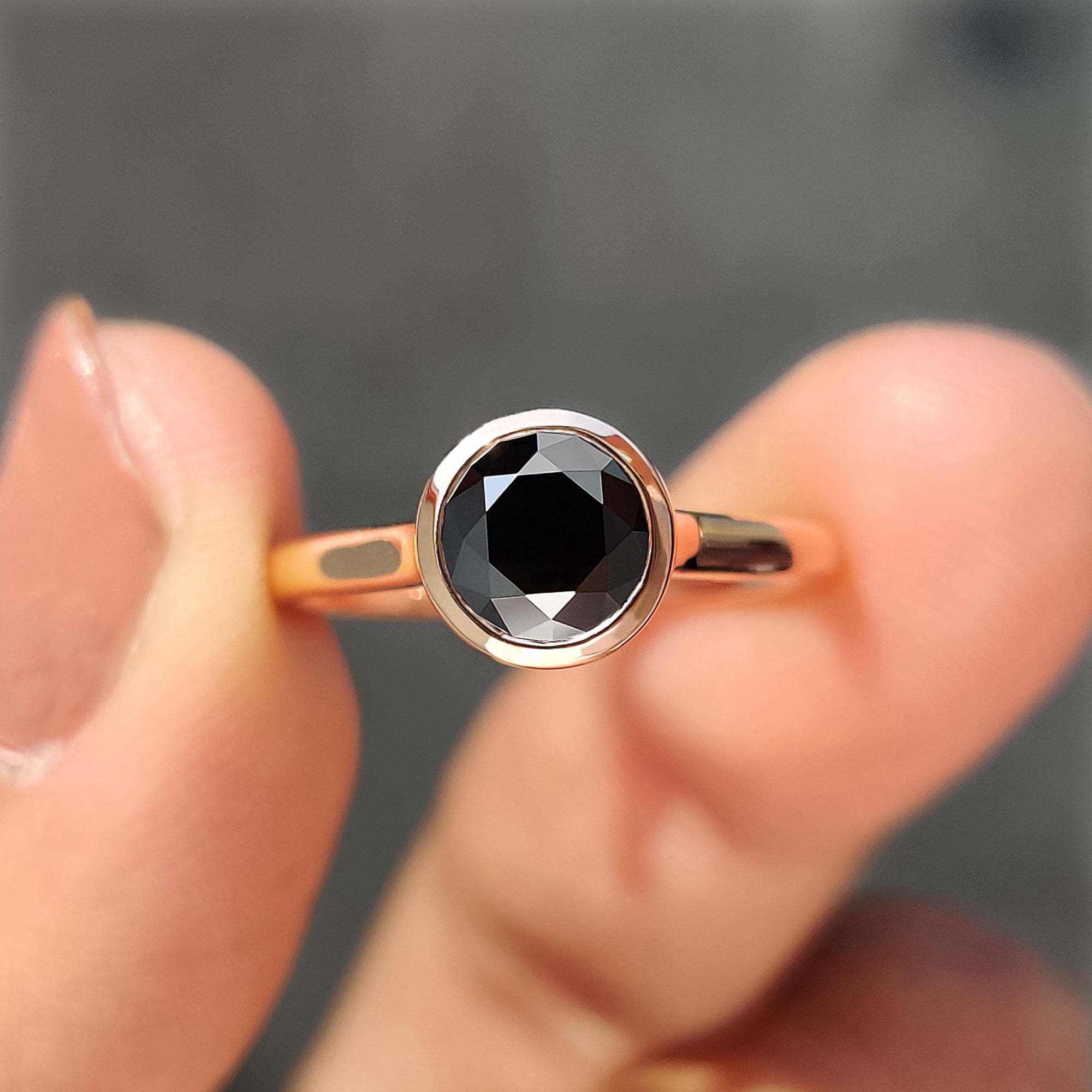 Black Moissanite ring in a classic bezel setting with a round cut centre stone.
