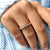 Rose gold wedding band with moissanite stones, offering a warm and refined look.