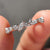 Multi shape moissanite band featuring marquise, round, and pear cuts in a prong setting.