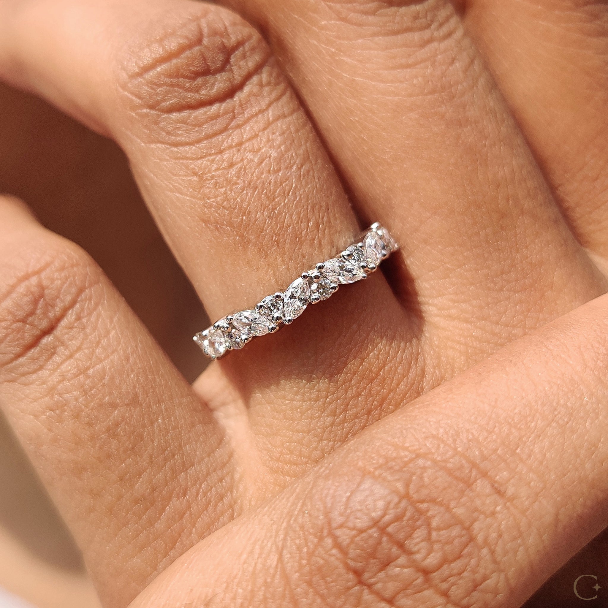 Handmade band with marquise and round diamond design.
