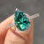 Moissanite Pear Ring in white gold with round cut pave set band
