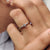 White gold wedding band featuring two moissanite stones.