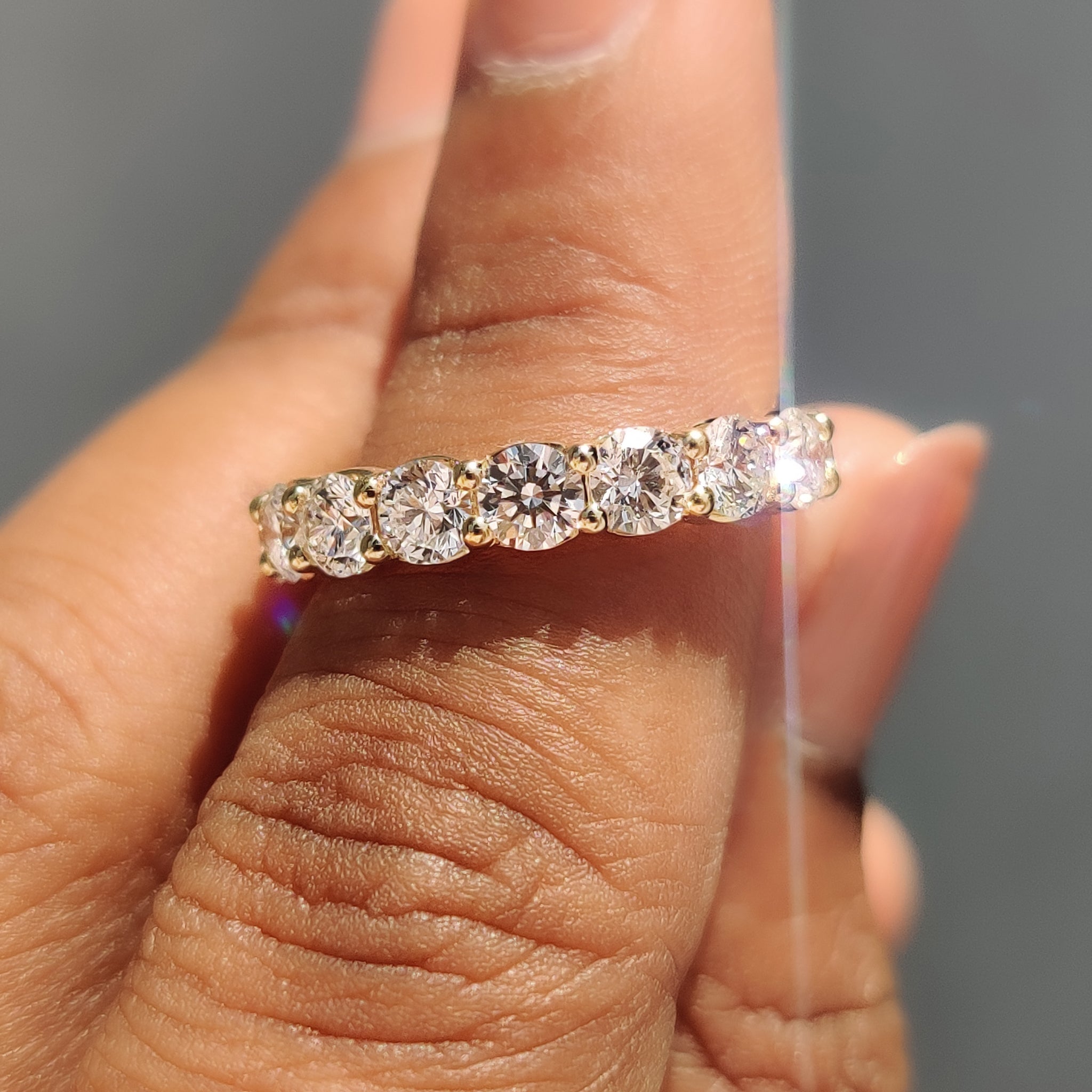 Prong set round diamonds in a handmade wedding band.
