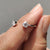 2 stone wedding band crafted in white gold with a clean open front design.
