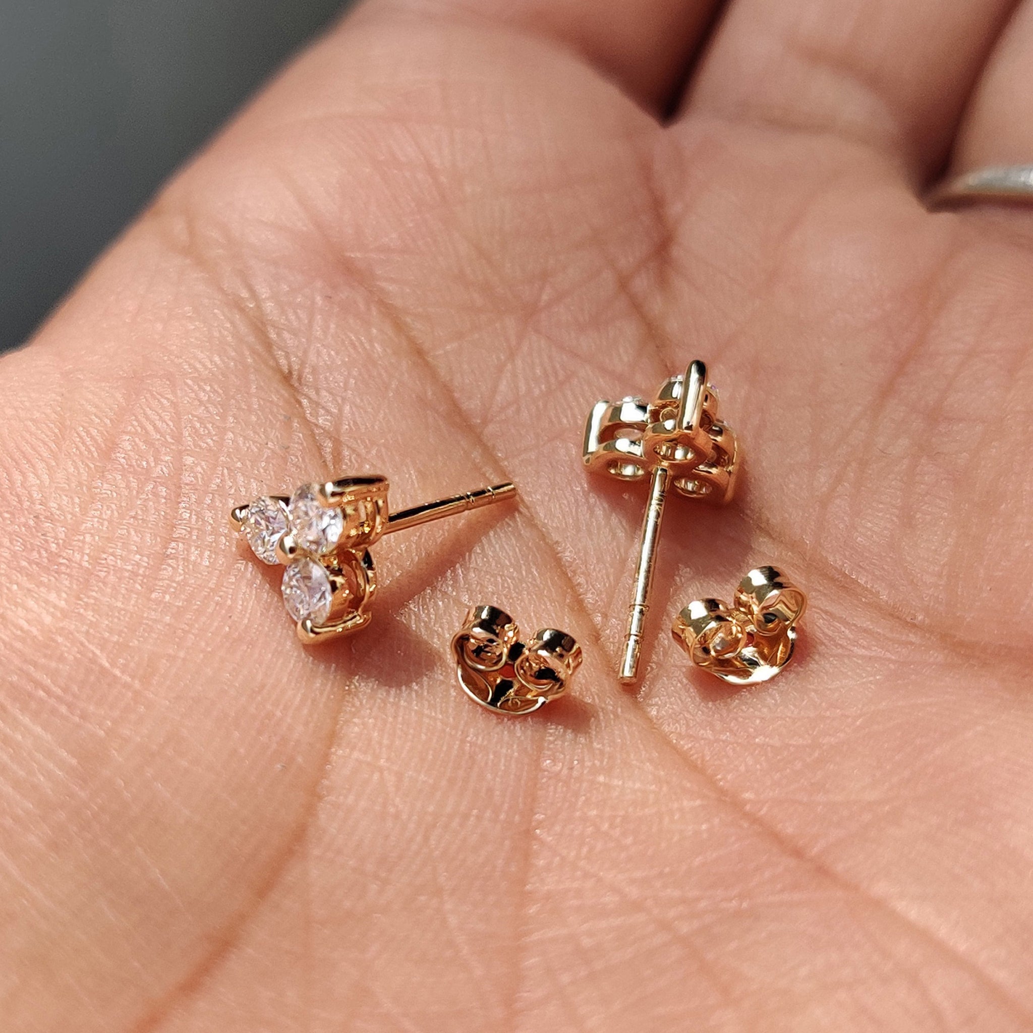 Moissanite earrings created in yellow gold with 3 Stone Stud Earring design.
