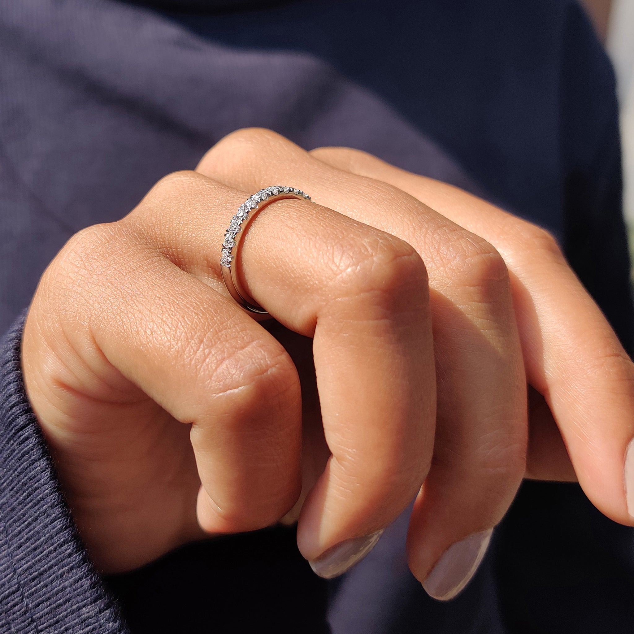 Buy Moissanite band featuring a stunning design with round stones in a half eternity style.