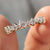 Simple gold wedding band with round cut moissanite in a clean prong setting.