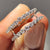 Pear shaped moissanite band designed with a soft curve for stacking or matching.