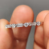 Artisan-crafted handmade jewelry featuring a half eternity white gold band with moissanite.