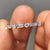 Artisan-crafted handmade jewelry featuring a half eternity white gold band with moissanite.