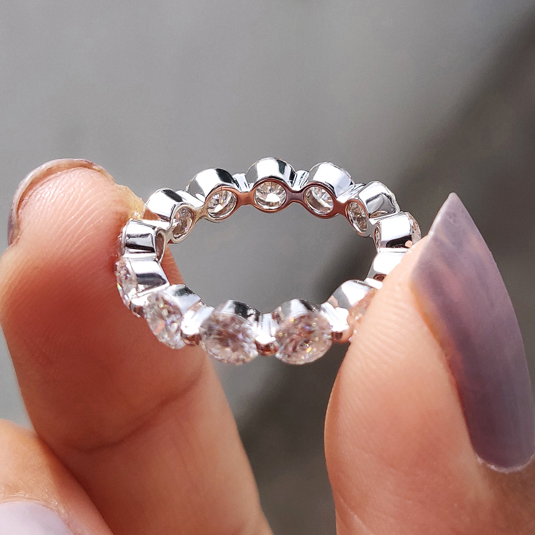 Full eternity band featuring a continuous row of stones.