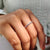 Round moissanite wedding band crafted in durable white gold.
