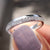 Handmade band with a classic round moissanite design for a timeless look.