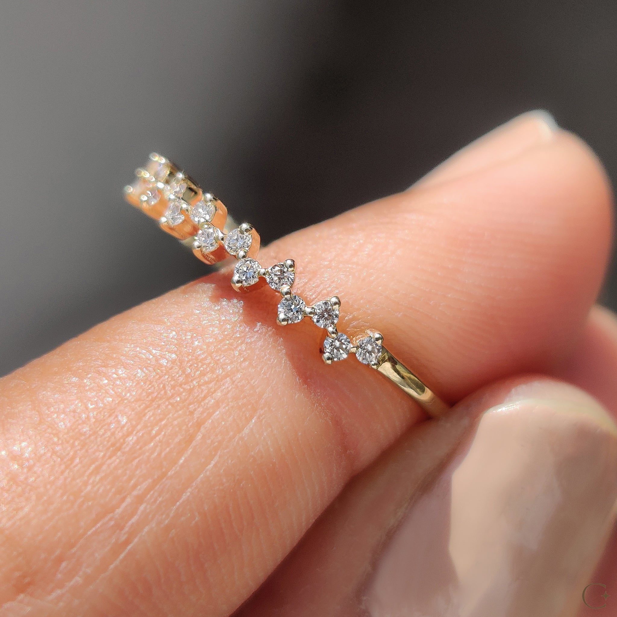 Round diamond wedding band displayed on a soft satin cloth.
