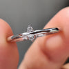 3 prong setting holding round moissanite stone.