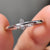 3 prong setting holding round moissanite stone.